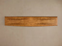 Top view of the Palma Media Console's light brown cerajeira wood veneer top with distinct arched graining.